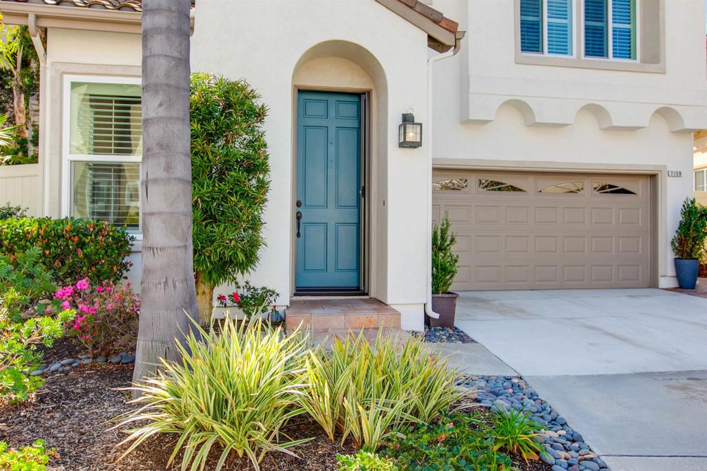 7159 Tanager Drive Carlsbad, CA 92011 - Photo 7 of 68 a front view of a house with a yard and flowers