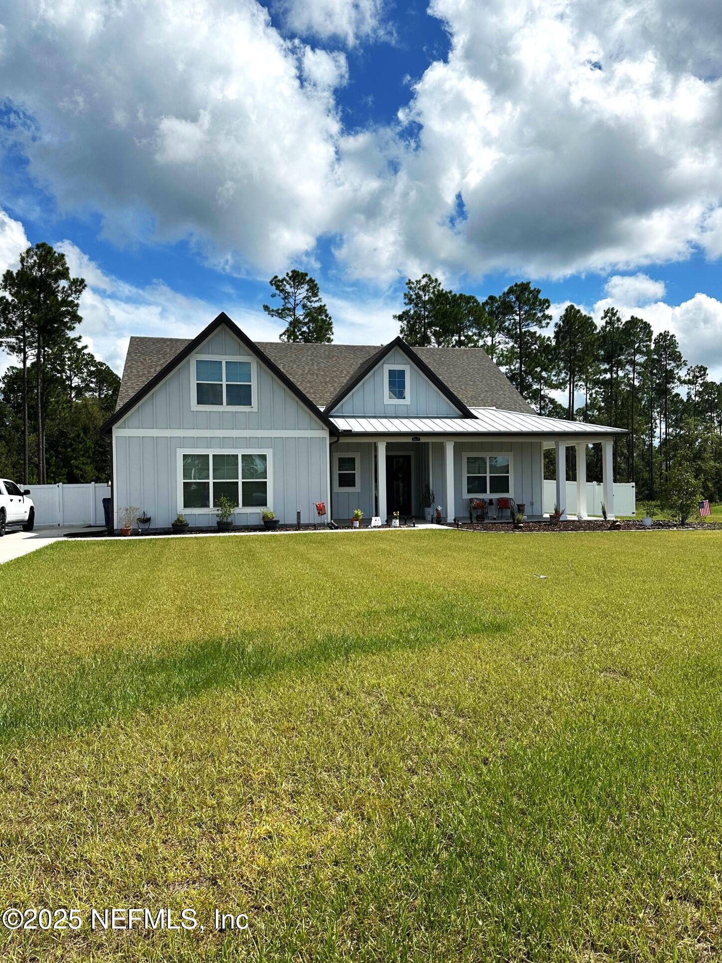 36079 Pitch Lane Hilliard, FL 32046 - Photo 1 of 35 a house with swimming pool in front of it