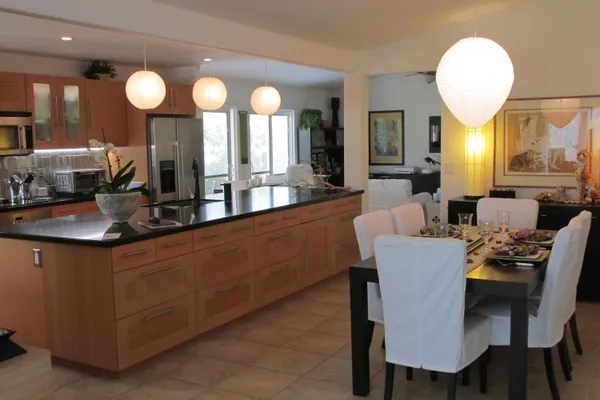 a large kitchen with a table and chairs