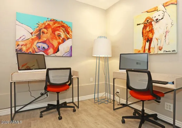 a bench sitting in a room next to a lamp
