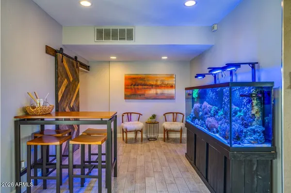 a living room with furniture and wooden floor