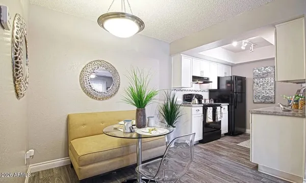 a living room with furniture kitchen view and large window