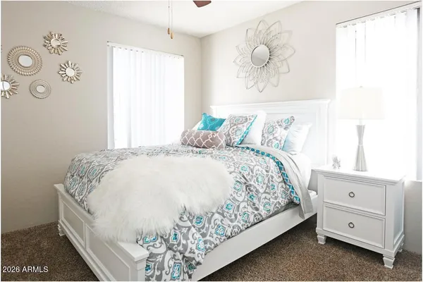 a bedroom with a bed and a window