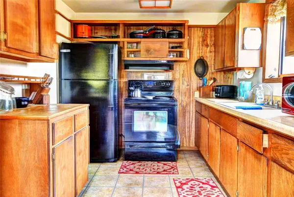 a kitchen with stainless steel appliances granite countertop a sink and a cabinets