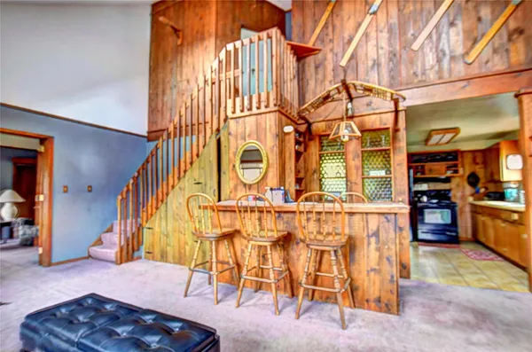 a view of a dining room with furniture and chandelier
