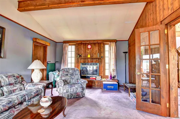 a living room with furniture fireplace and a large window