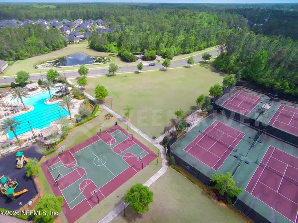 an aerial view of a swimming pool patio and outdoor seating