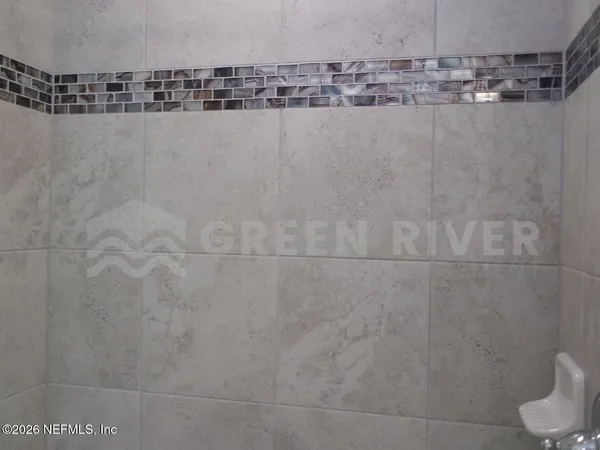 a bathroom with a glass shower door