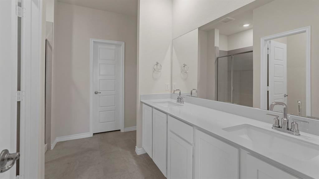 447 Epiphany Lane Lavon, TX 75166 - Photo 19 of 31 Double vanity with integrated sinks, white countertops, and chrome fixtures