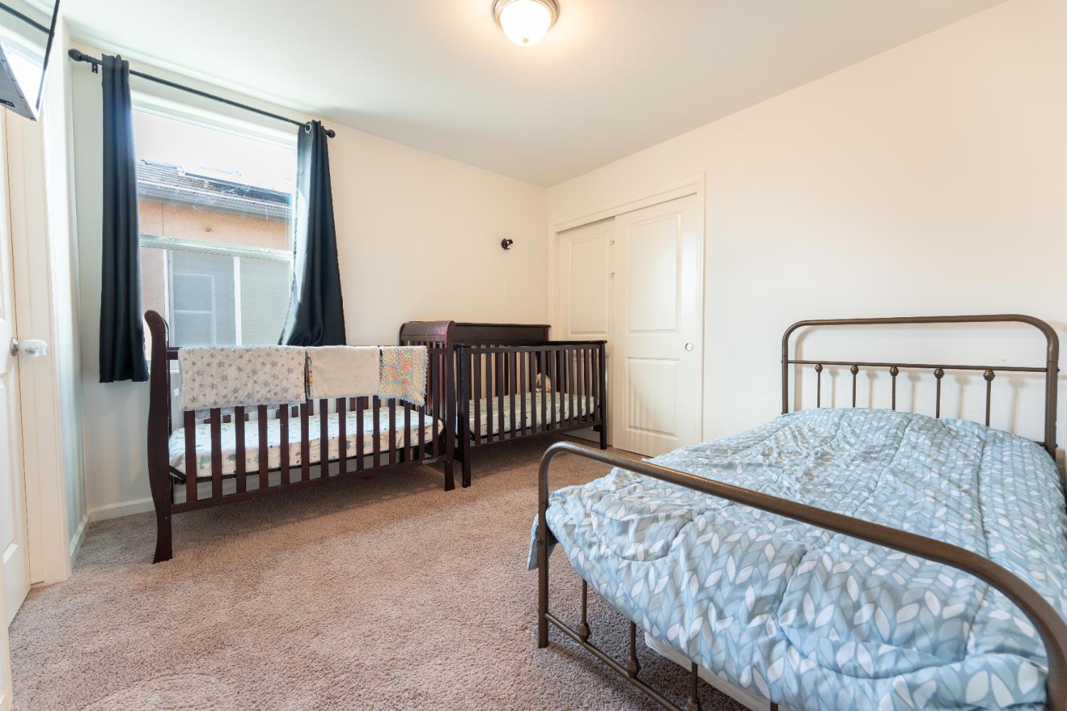 835 Fir Street Madera, CA 93636 - Photo 17 of 21 a bedroom with a bed and a window