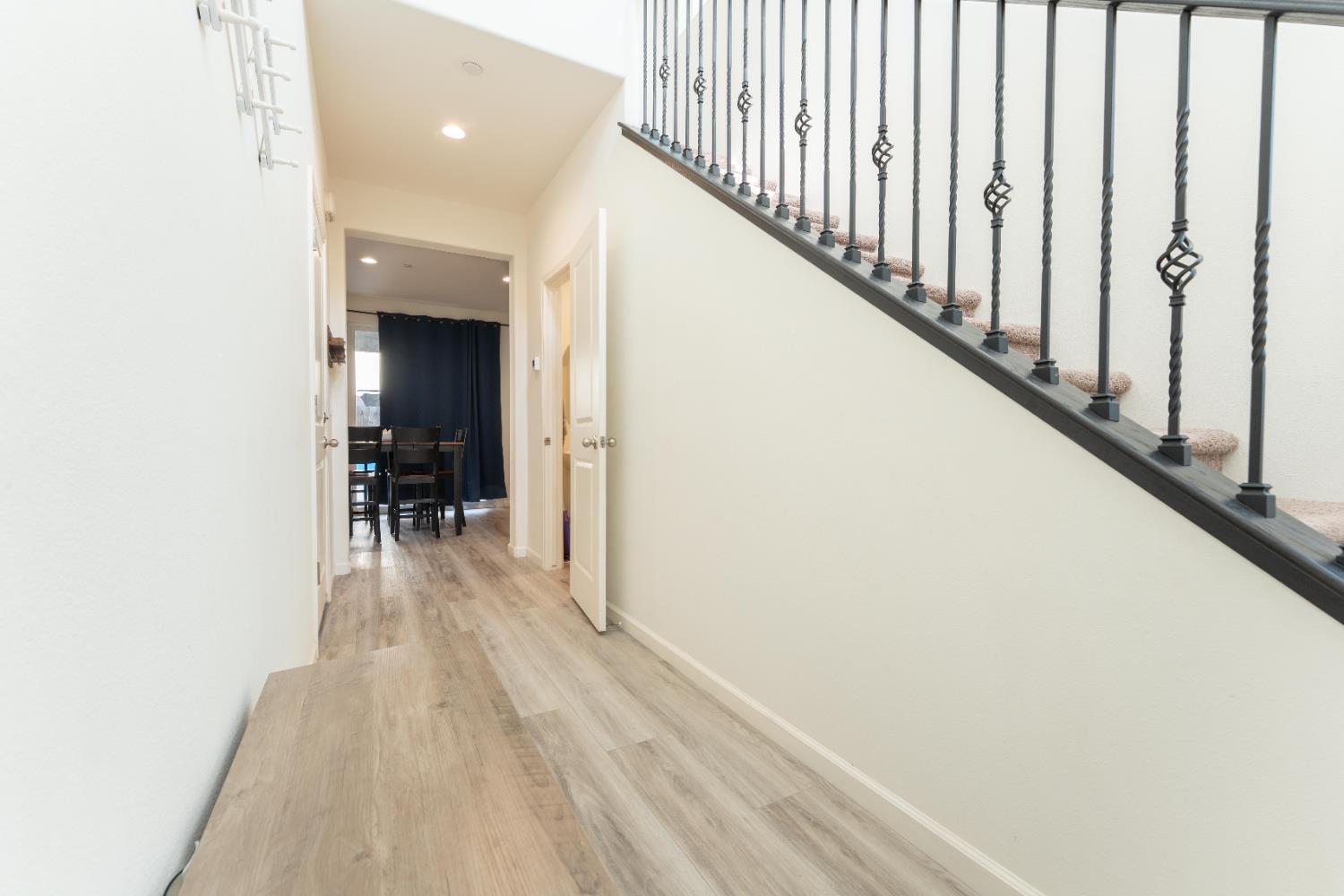 835 Fir Street Madera, CA 93636 - Photo 3 of 21 a view of a hallway with wooden floor and staircase