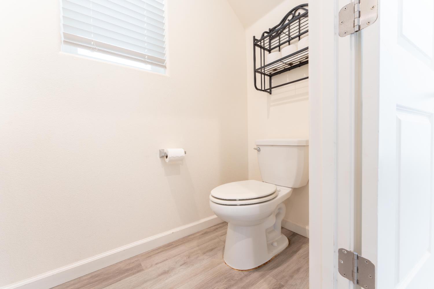 835 Fir Street Madera, CA 93636 - Photo 4 of 21 a bathroom with a toilet and a vanity