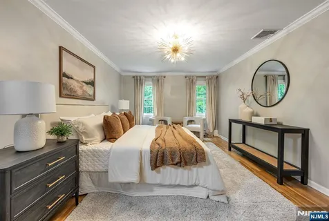 a spacious bedroom with a bed and a chandelier