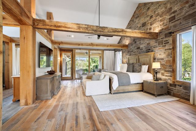 a spacious bedroom with a bed and a large window