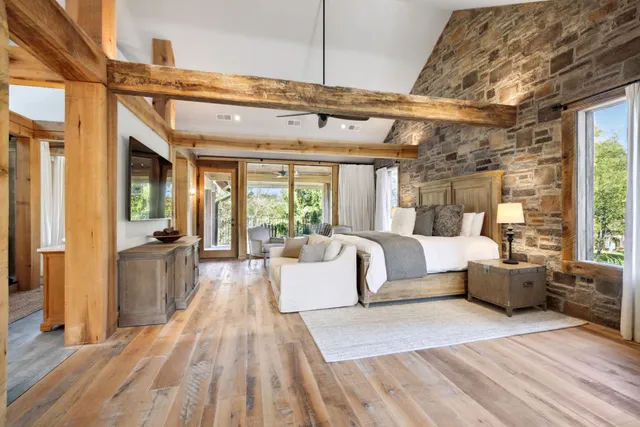 a spacious bedroom with a bed and a large window