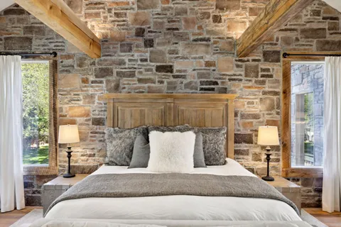 a spacious bedroom with a bed couch and a window