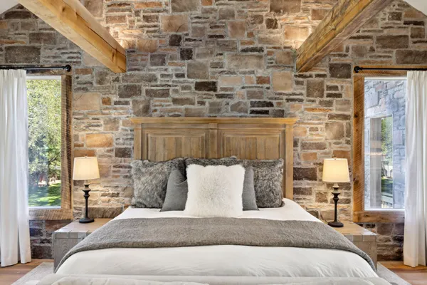 a spacious bedroom with a bed couch and a window