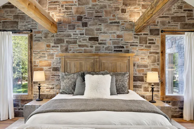 a spacious bedroom with a bed couch and a window