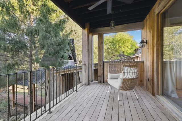 a very nice looking living room with a large window and chandelier