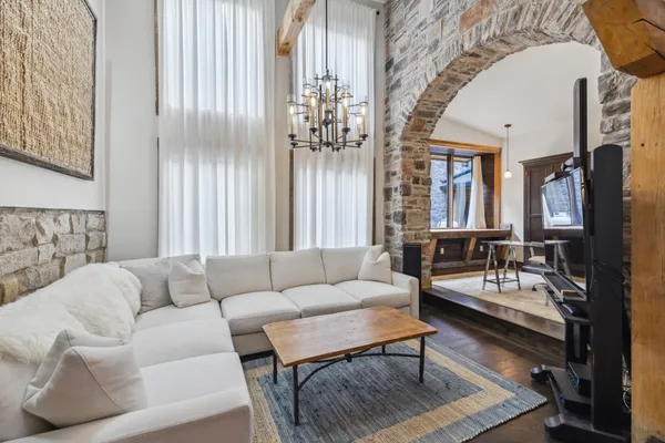 a view of a kitchen with kitchen island granite countertop a sink appliances cabinets and a large window