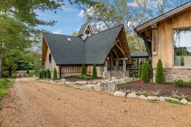 an aerial view of residential houses with outdoor space and trees