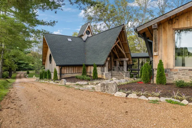 an aerial view of residential houses with outdoor space and trees