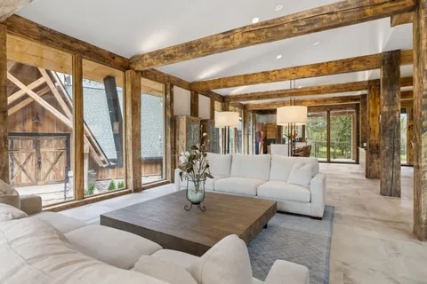 a living room with furniture and large windows