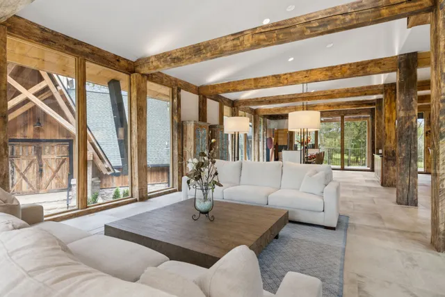 a living room with furniture and large windows