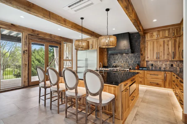 a kitchen with granite countertop a sink a stove and cabinets