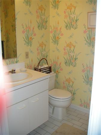 63 Garden Road, Unit G8 Wellesley, MA 02481 - Photo 12 of 12 a bathroom with a sink a toilet and a mirror