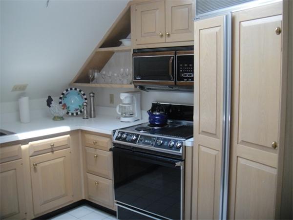 63 Garden Road, Unit G8 Wellesley, MA 02481 - Photo 7 of 12 a kitchen with cabinets and steel stainless steel appliances