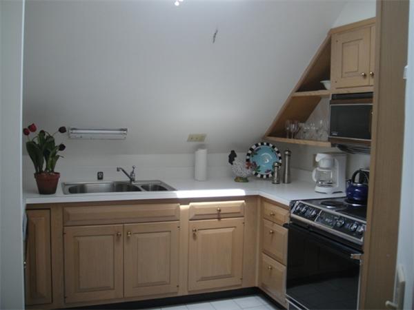 63 Garden Road, Unit G8 Wellesley, MA 02481 - Photo 8 of 12 a kitchen with white cabinets and appliances