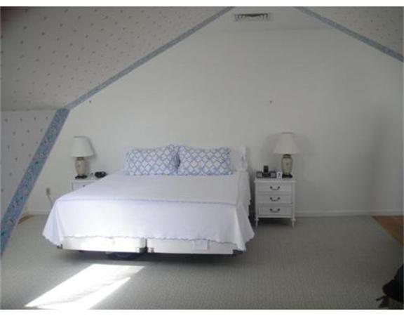 63 Garden Road, Unit G8 Wellesley, MA 02481 - Photo 9 of 12 a bed sitting in a bedroom next to a window