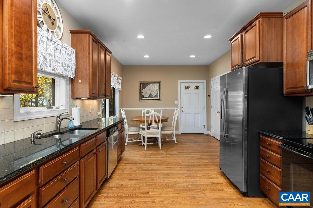 59 Timber Ridge Lane Roseland, VA 22967 - Photo 13 of 45 a kitchen with stainless steel appliances granite countertop wooden cabinets a refrigerator a sink a stove and a wooden floors