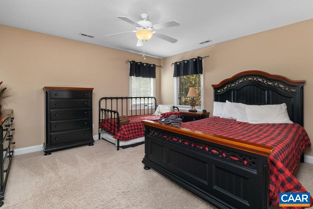 59 Timber Ridge Lane Roseland, VA 22967 - Photo 19 of 45 a bedroom with a bed and a chandelier