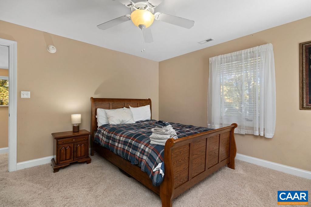 59 Timber Ridge Lane Roseland, VA 22967 - Photo 24 of 45 a bedroom with a bed lamp and a chandelier