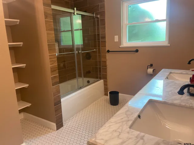 a bathroom with a tub and a window