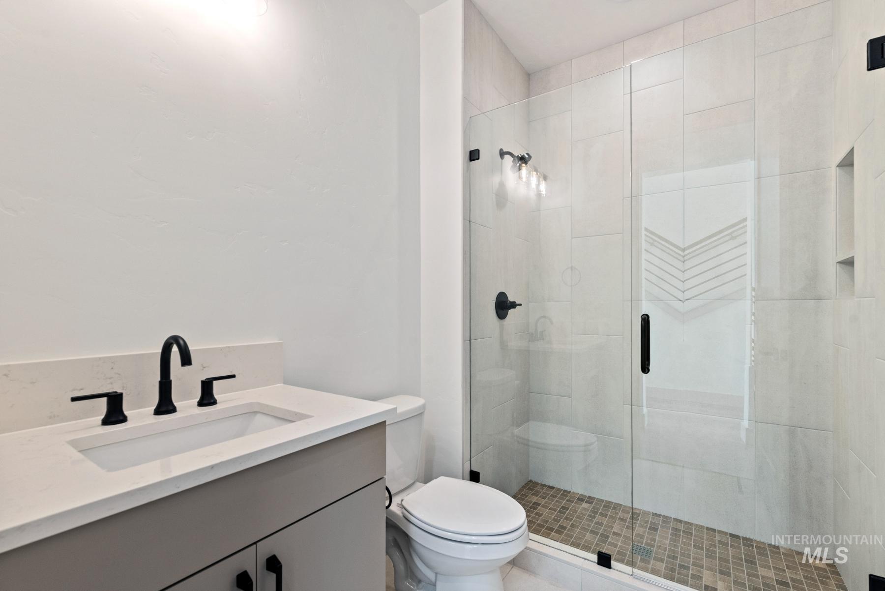 8482 West Graye Street, Unit ALPINE Meridian, ID 83646 - Photo 17 of 19 Full bathroom featuring vanity and a stall shower