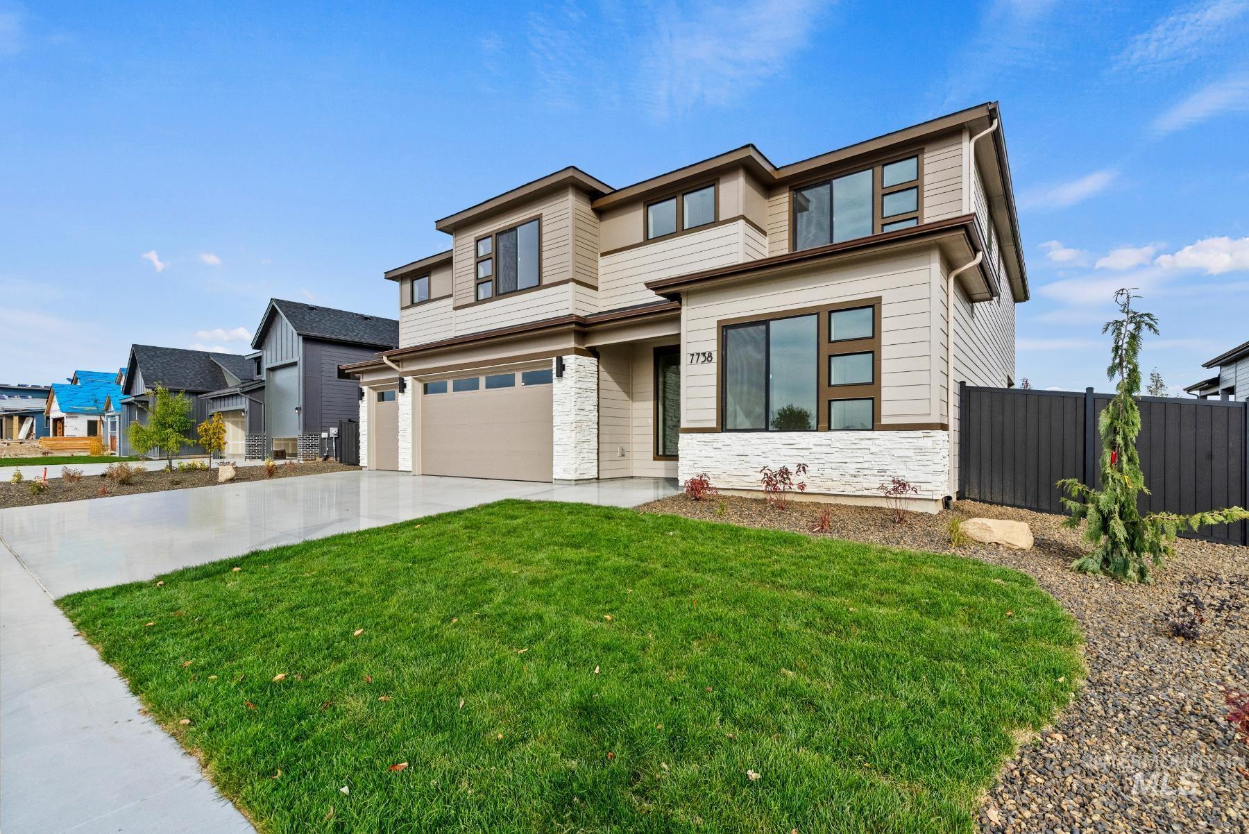 8482 West Graye Street, Unit ALPINE Meridian, ID 83646 - Photo 2 of 19 Prairie-style house featuring stone siding, concrete driveway, and an attached garage