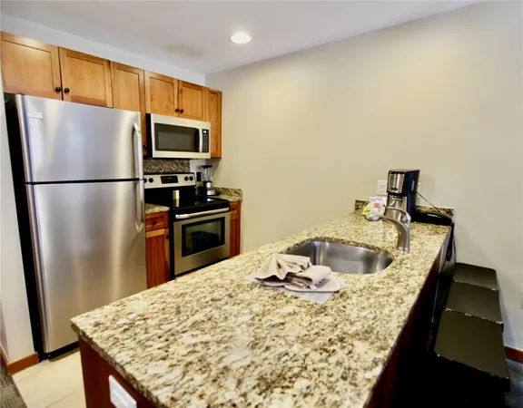 a kitchen with a refrigerator and a sink