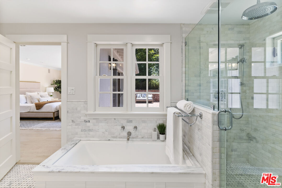 9520 Gloaming Drive Beverly Hills, CA 90210 - Photo 21 of 44 a bathroom with a tub shower and sink