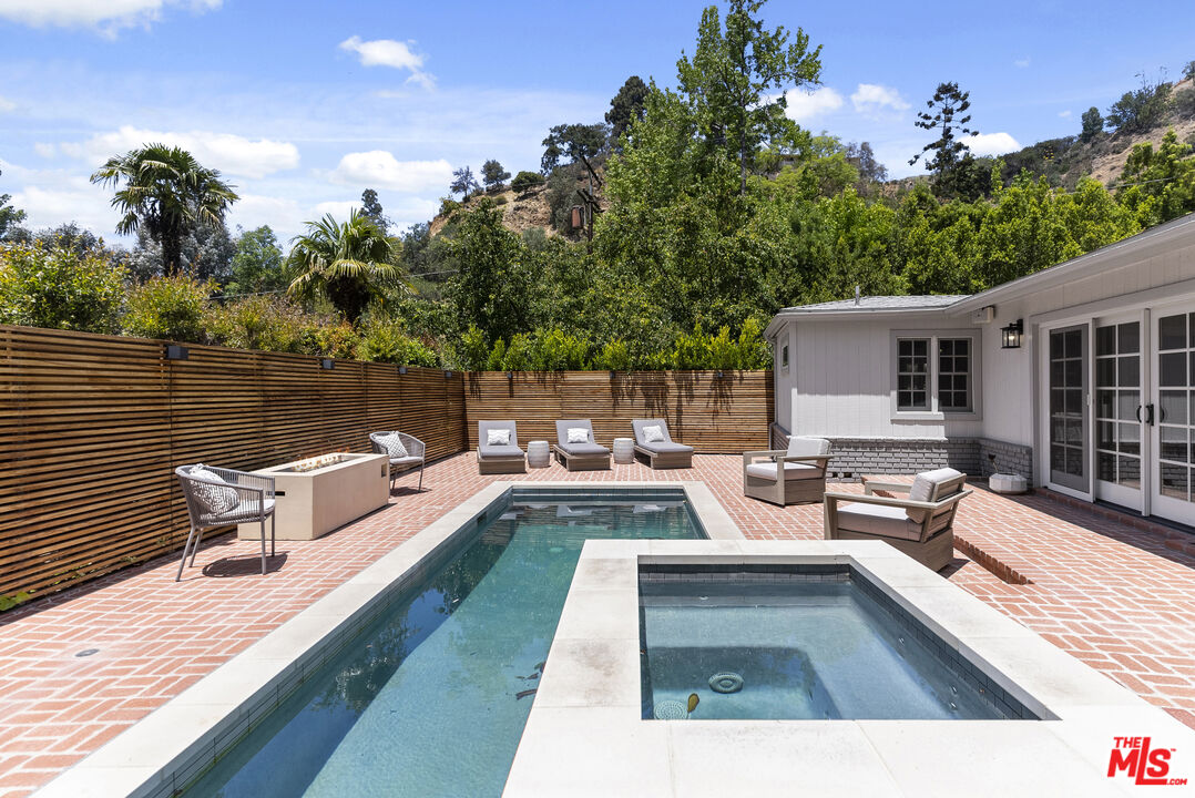 9520 Gloaming Drive Beverly Hills, CA 90210 - Photo 32 of 44 a view of a patio with couches chairs and wooden floor