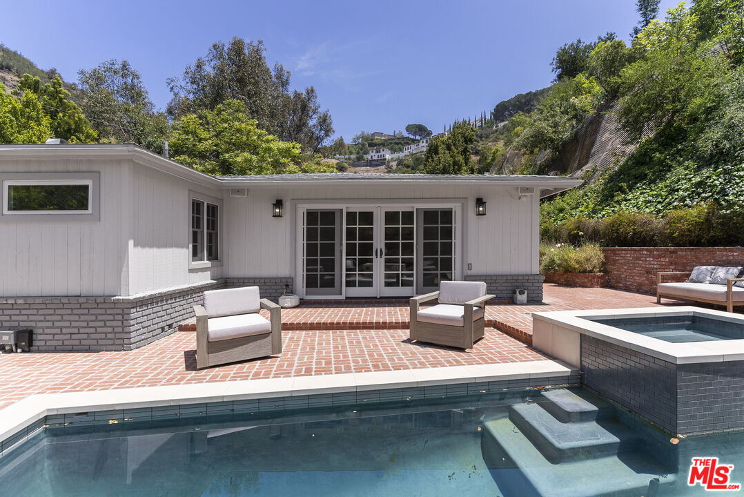 9520 Gloaming Drive Beverly Hills, CA 90210 - Photo 33 of 44 a view of a patio with couches table and chairs with wooden floor and fence