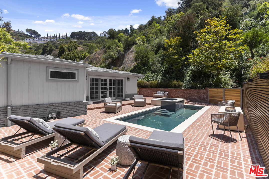 9520 Gloaming Drive Beverly Hills, CA 90210 - Photo 35 of 44 a view of a patio with couches table and chairs with wooden floor