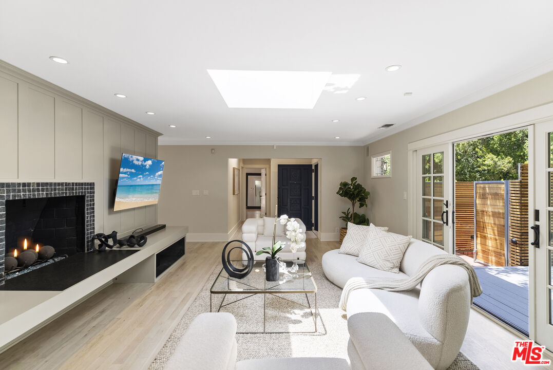 9520 Gloaming Drive Beverly Hills, CA 90210 - Photo 5 of 44 a living room with furniture a flat screen tv and a fireplace