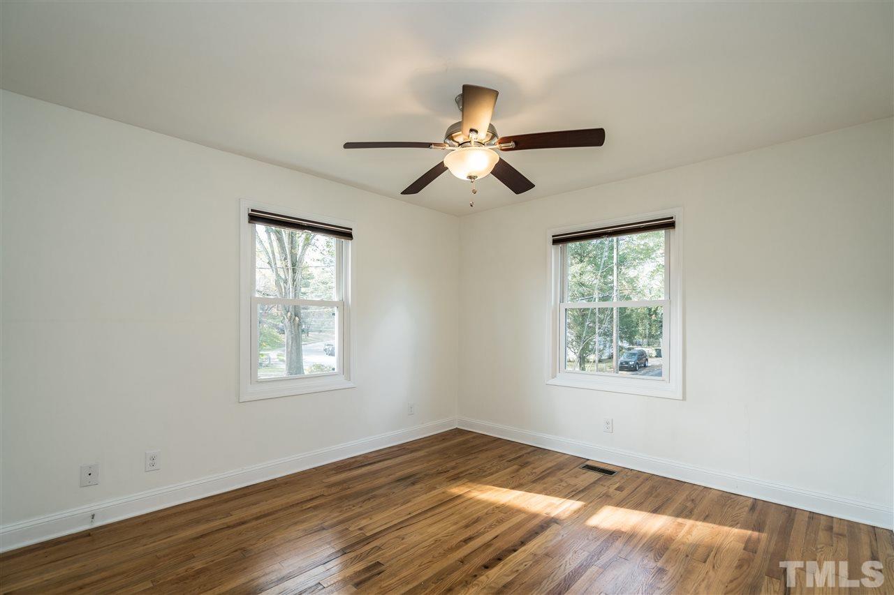 606 North King Charles Road Raleigh, NC 27610 - Photo 14 of 22 a view of an empty room with wooden floor and a window