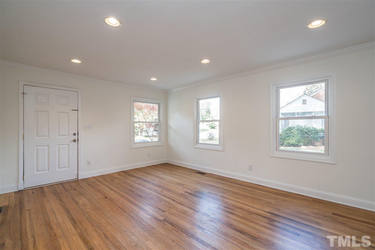 606 North King Charles Road Raleigh, NC 27610 - Photo 4 of 22 a view of an empty room with wooden floor and a window