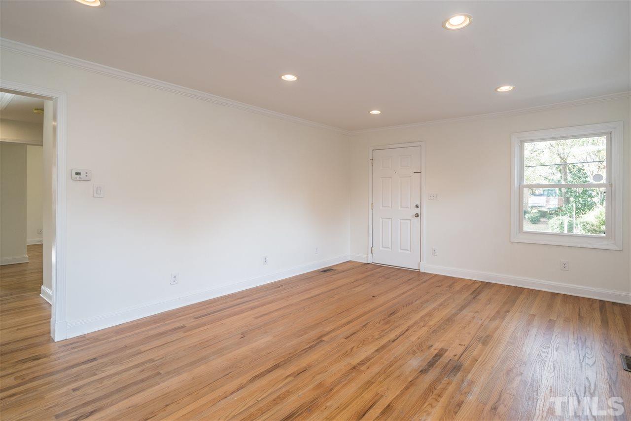 606 North King Charles Road Raleigh, NC 27610 - Photo 5 of 22 an empty room with wooden floor and windows