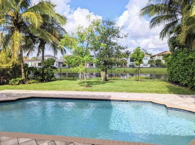an aerial view of a house with a garden and lake view