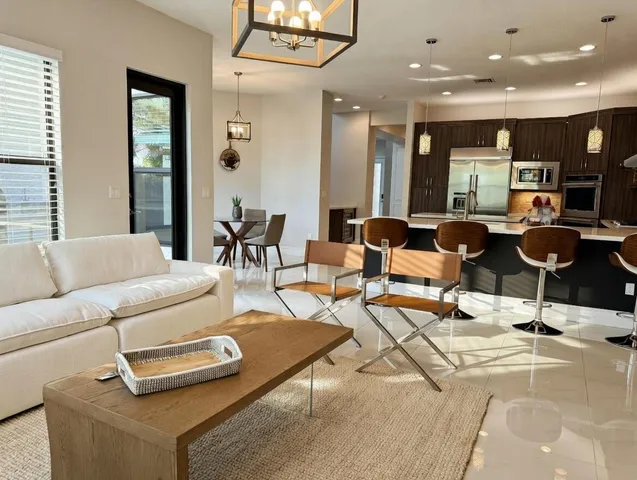 a view of a dining room with furniture and a window